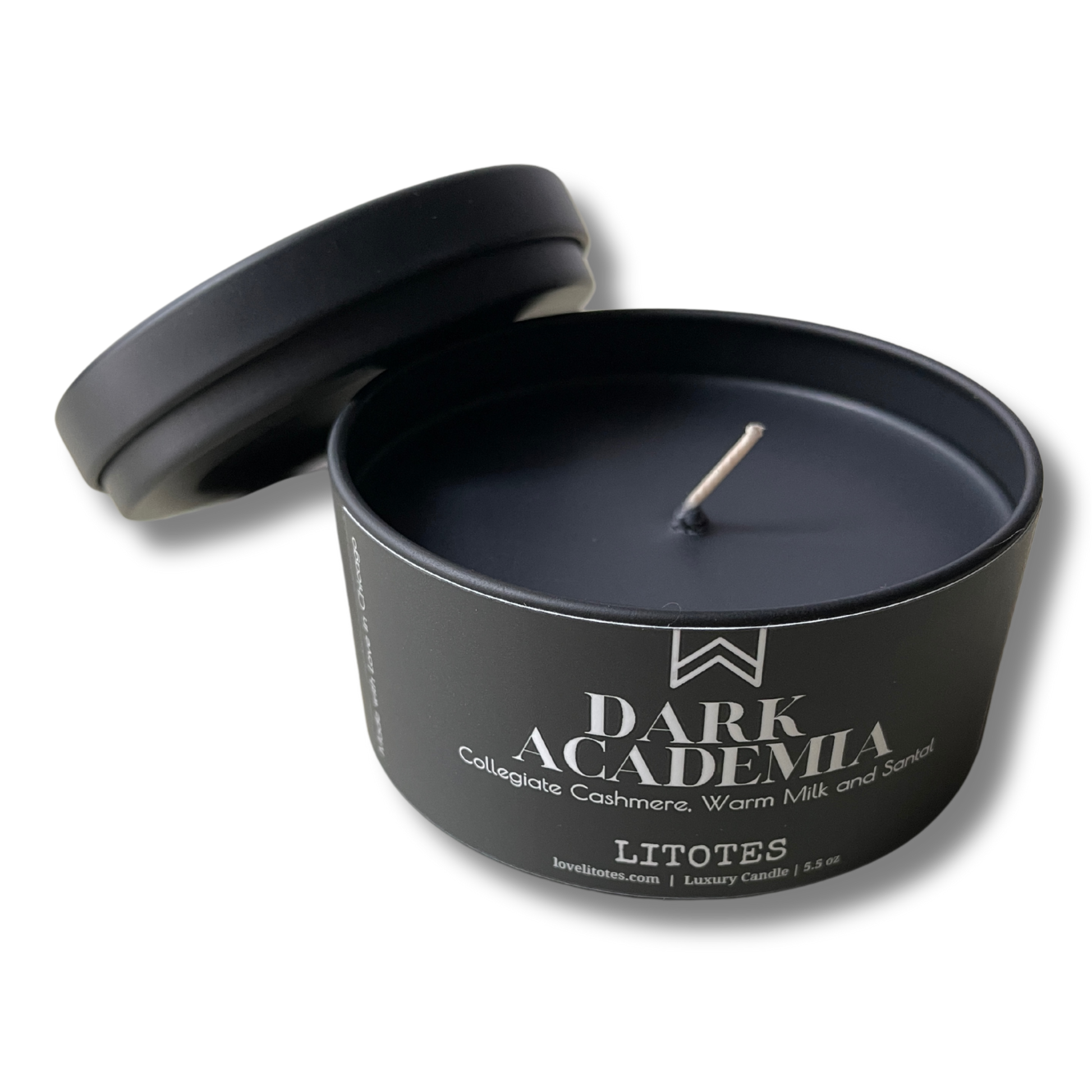 Black candle in a tin labeled 'Dark Academia' on a white background
