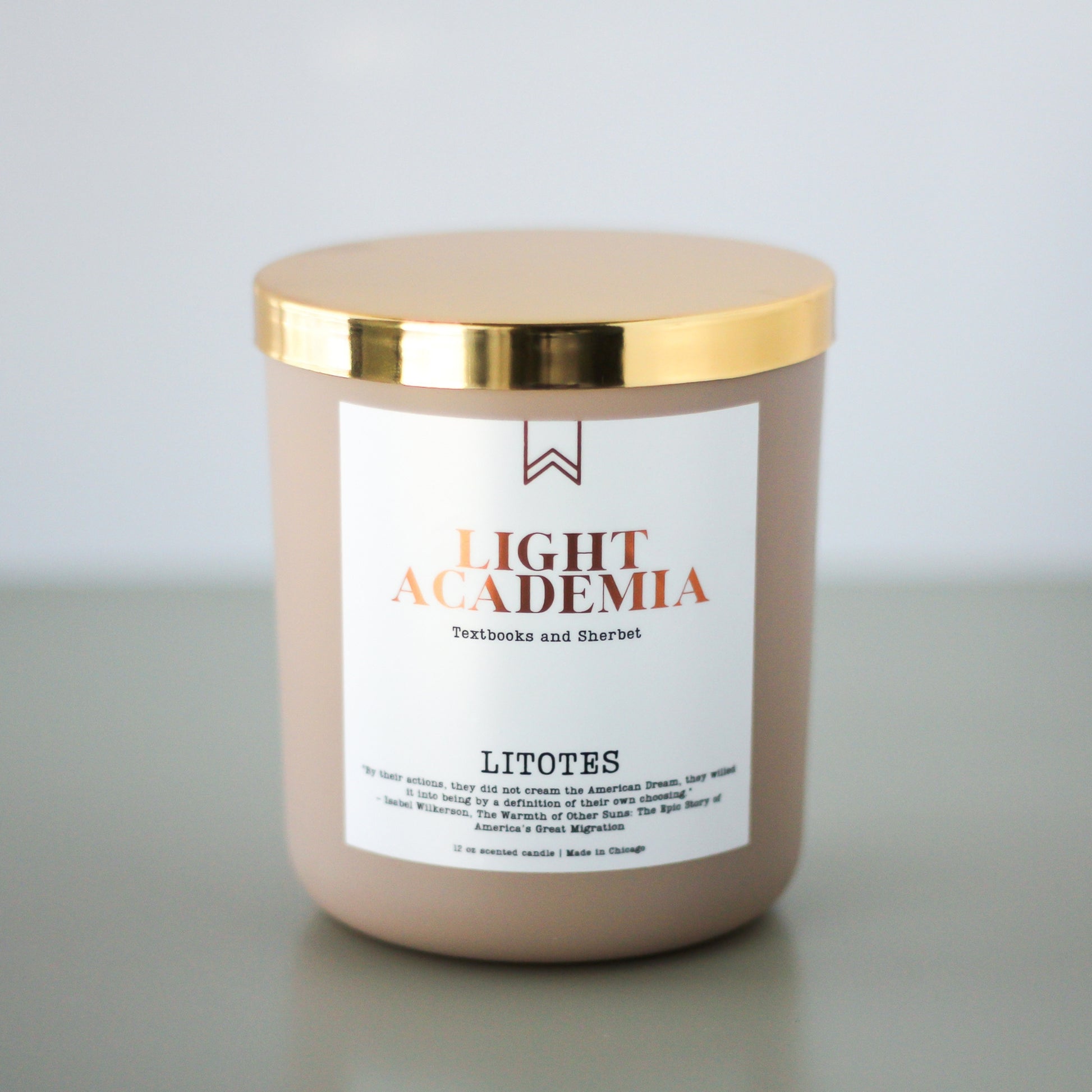A beige candle with a gold lid, labeled 'LIGHT ACADEMIA' with the word 'LITOTES' below it.