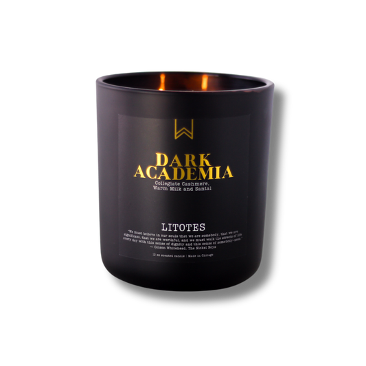 A black candle with the label 'DARK ACADEMIA' written in gold, along with the scent notes 'Collegiate Cashmere, Warm Milk and Santal'.